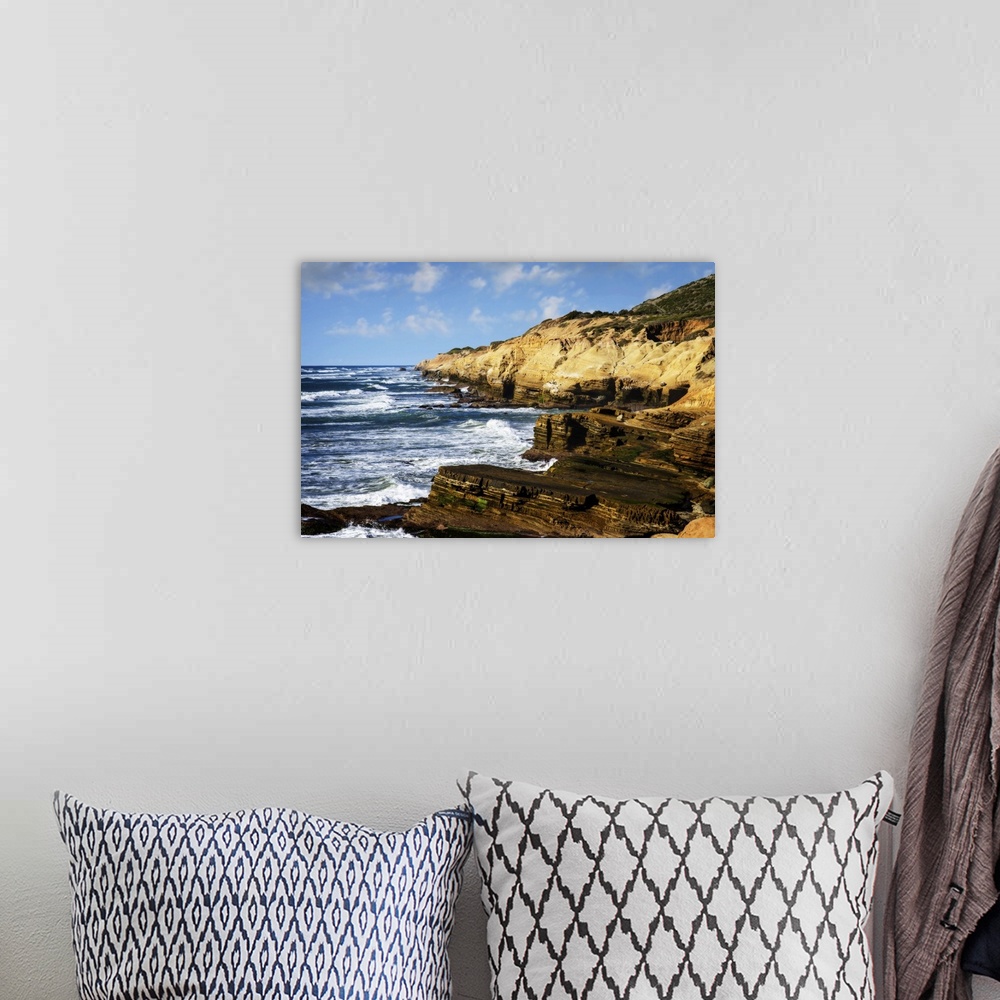 A bohemian room featuring Landscape photograph of waves crashing on rocky cliffs at Point Loma, CA.