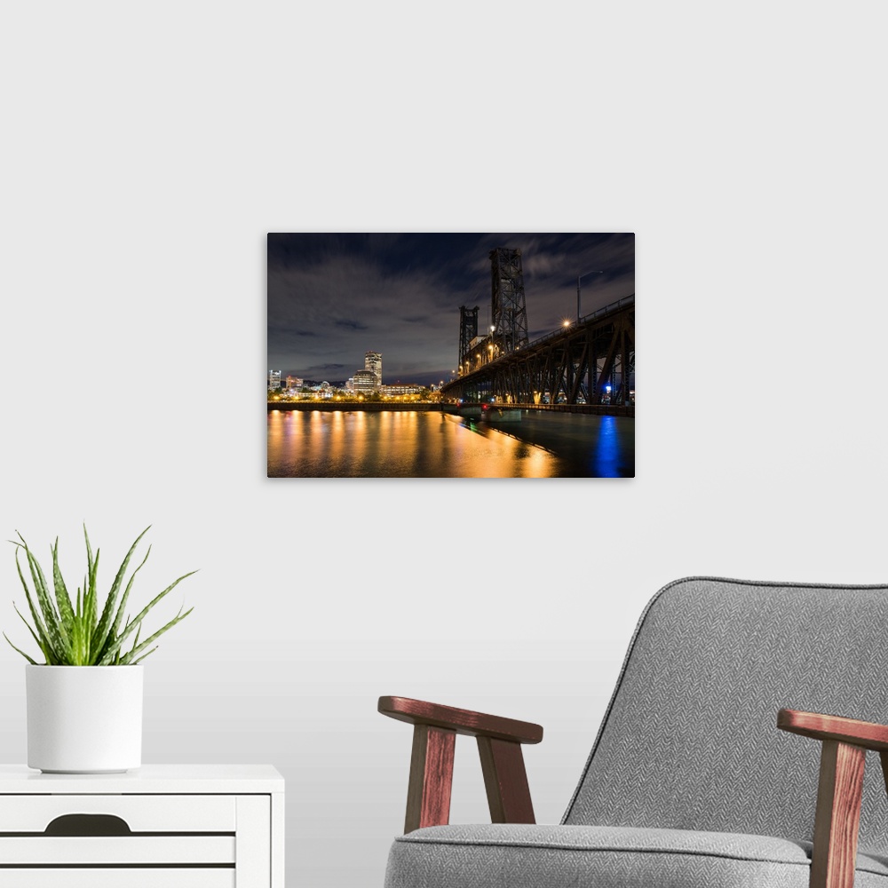 A modern room featuring Photograph of Portland lit up at night with the Willamette River in front and the Steel Bridge on...