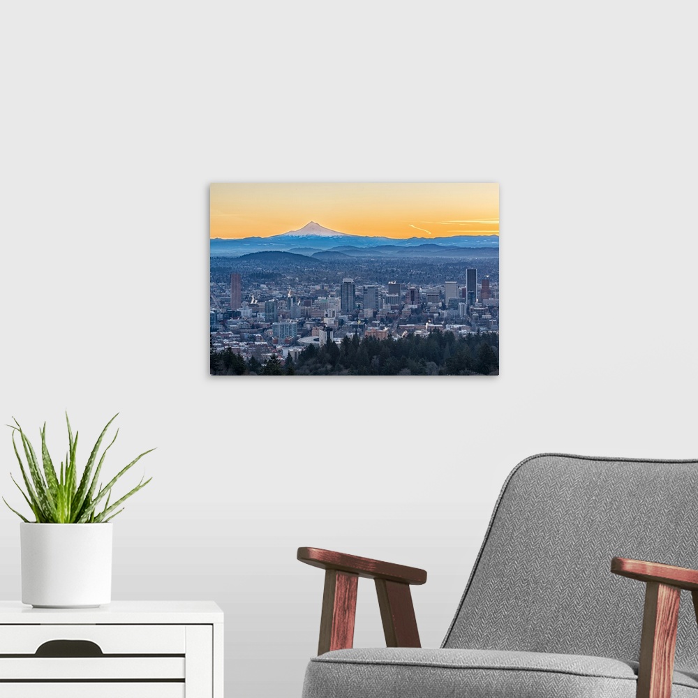 A modern room featuring Photograph of the city of Portland with rolling hills and Mt. Hood in the background, and an oran...