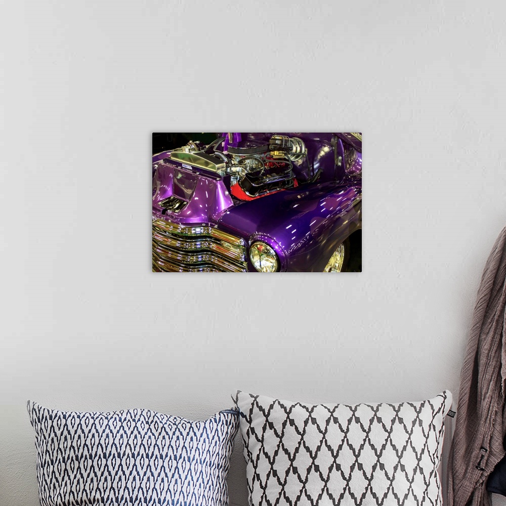 A bohemian room featuring Fine art photograph of a vintage car. The engine is visible and the paint job is a stunning purple.
