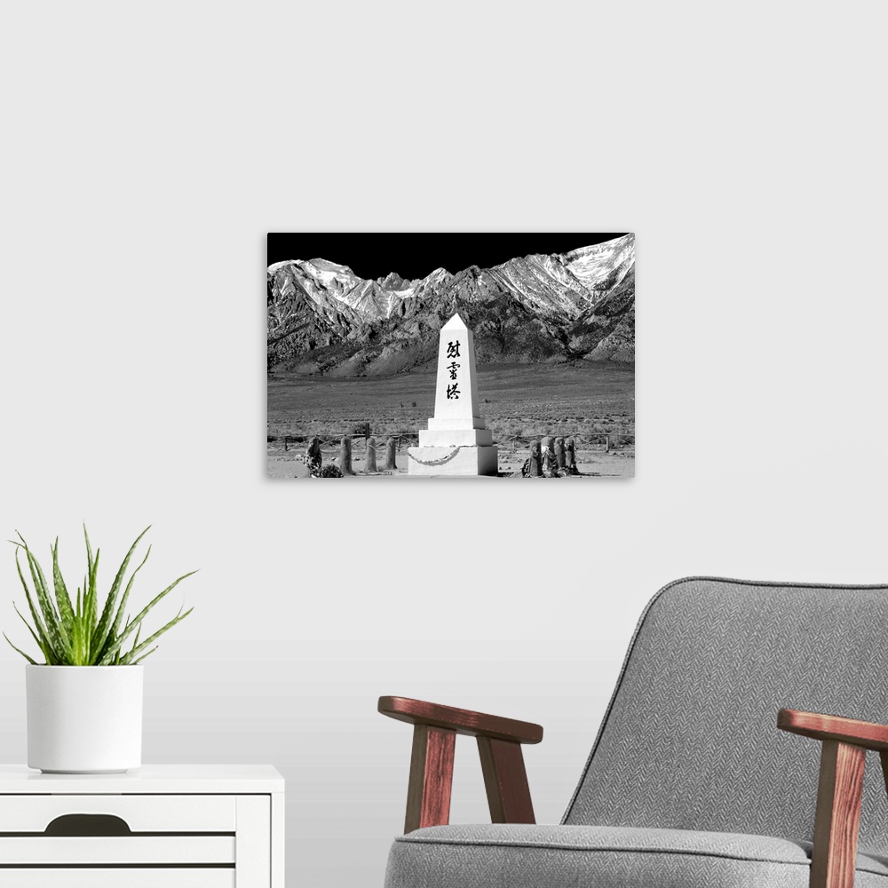 A modern room featuring Black and white photograph with a WWII monument in front of the Sierra Nevada mountain range.