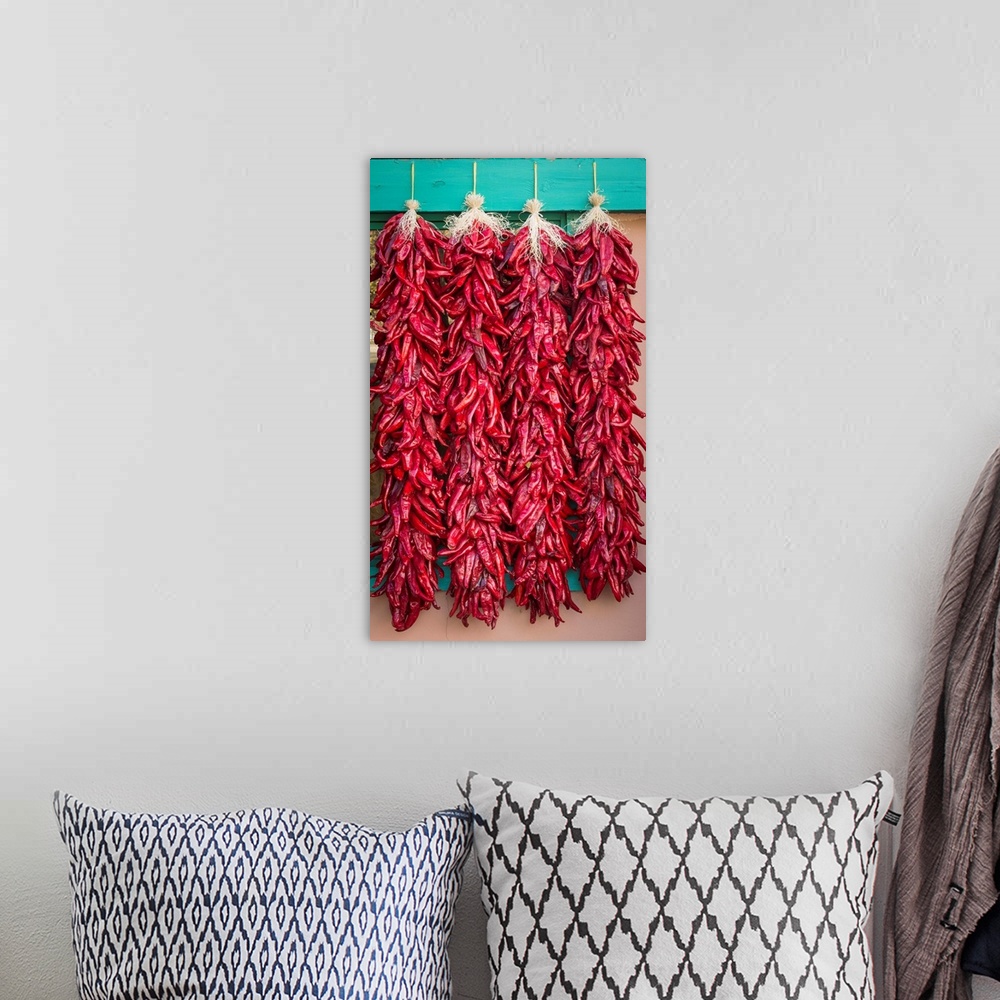 A bohemian room featuring Photograph of four strings of dried chilies.