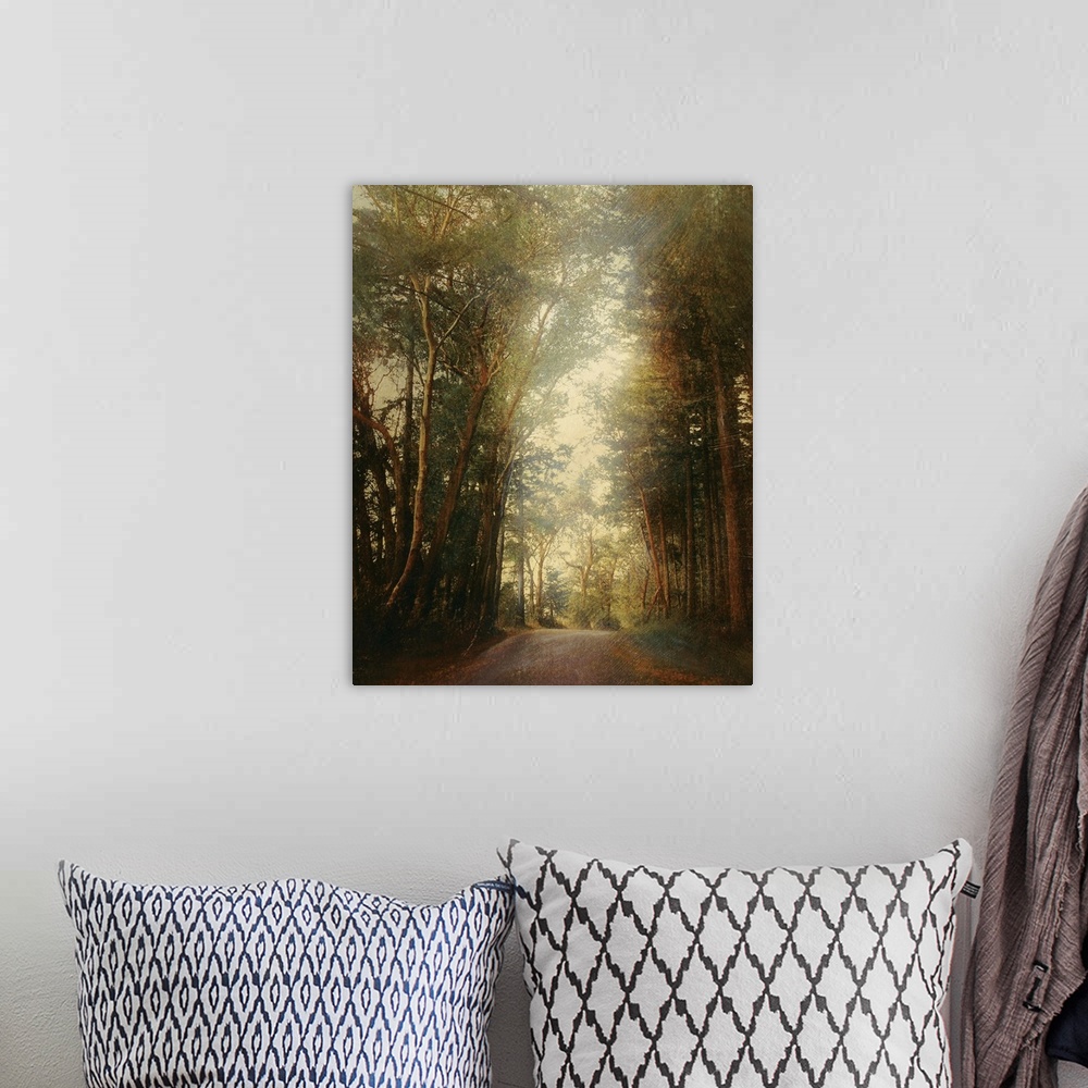 A bohemian room featuring Classical painting of stone pathway curving through forest on a foggy day.