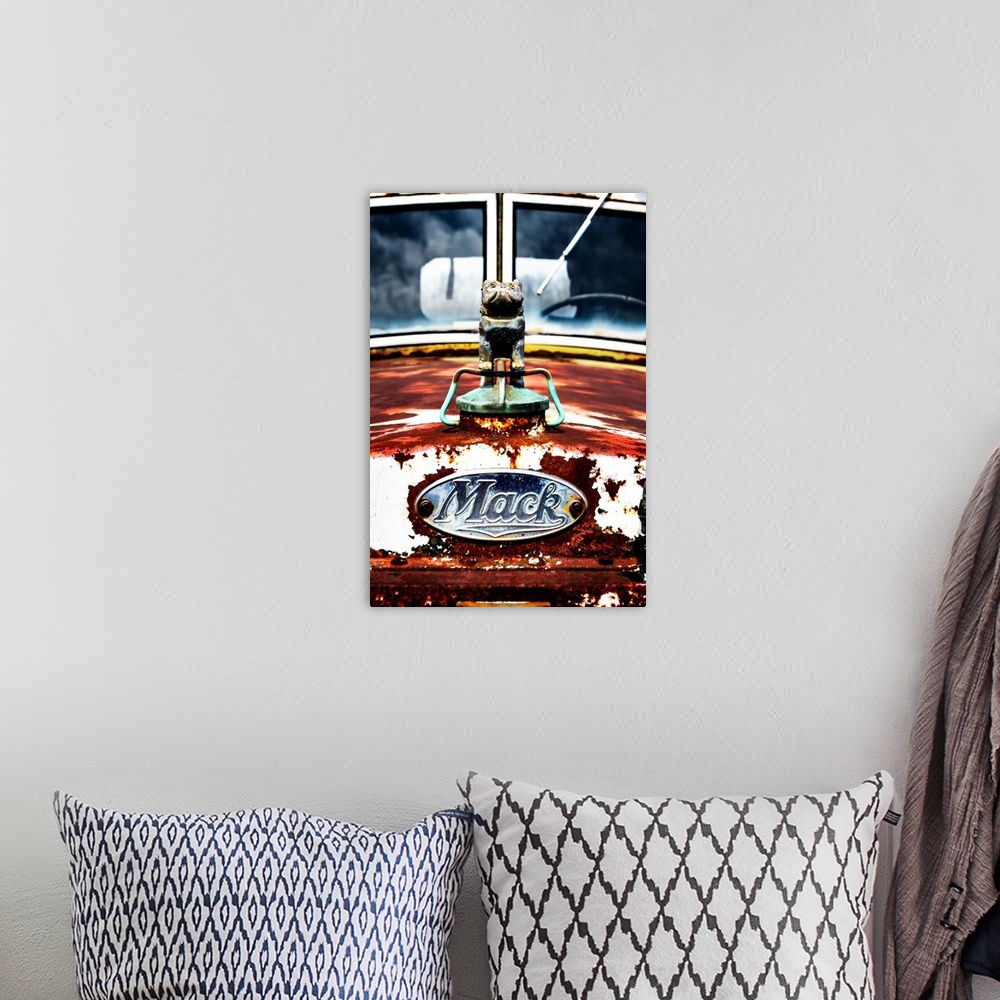 A bohemian room featuring Photograph of the front of an old, rusted Mack truck.