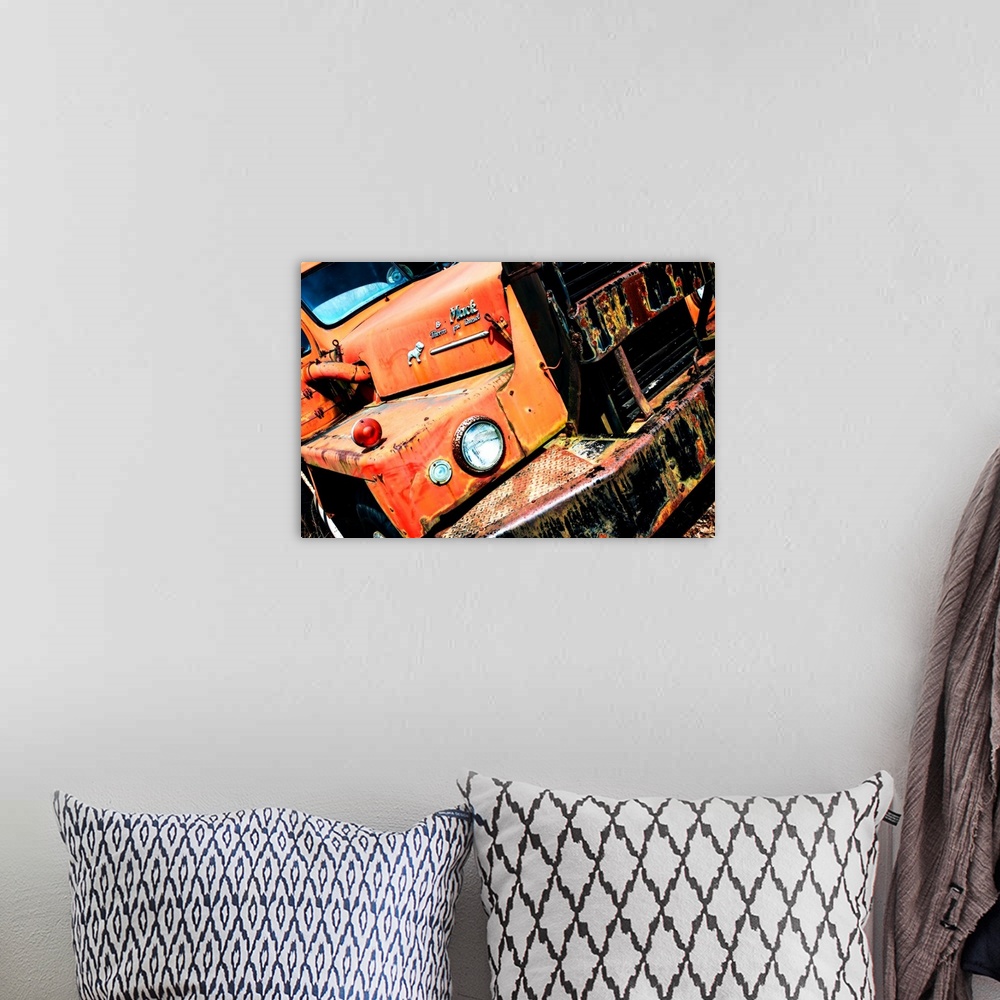 A bohemian room featuring Photograph of an old, rusted, orange Mack truck from a unique angle.