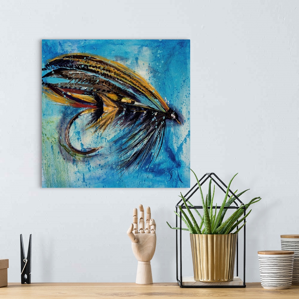 A bohemian room featuring Square painting of an orange, red, and black fly fishing lure on a blue and green background.