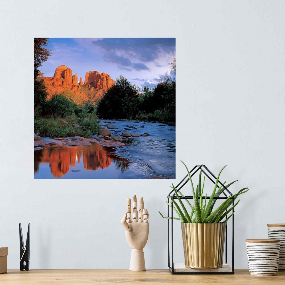 A bohemian room featuring Bright red rock formations in the distance near Sedona, Arizona.