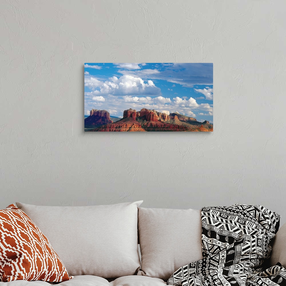 A bohemian room featuring Large white clouds over the desert landscape of Sedona, Arizona.