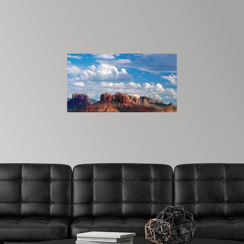 A modern room featuring Large white clouds over the desert landscape of Sedona, Arizona.