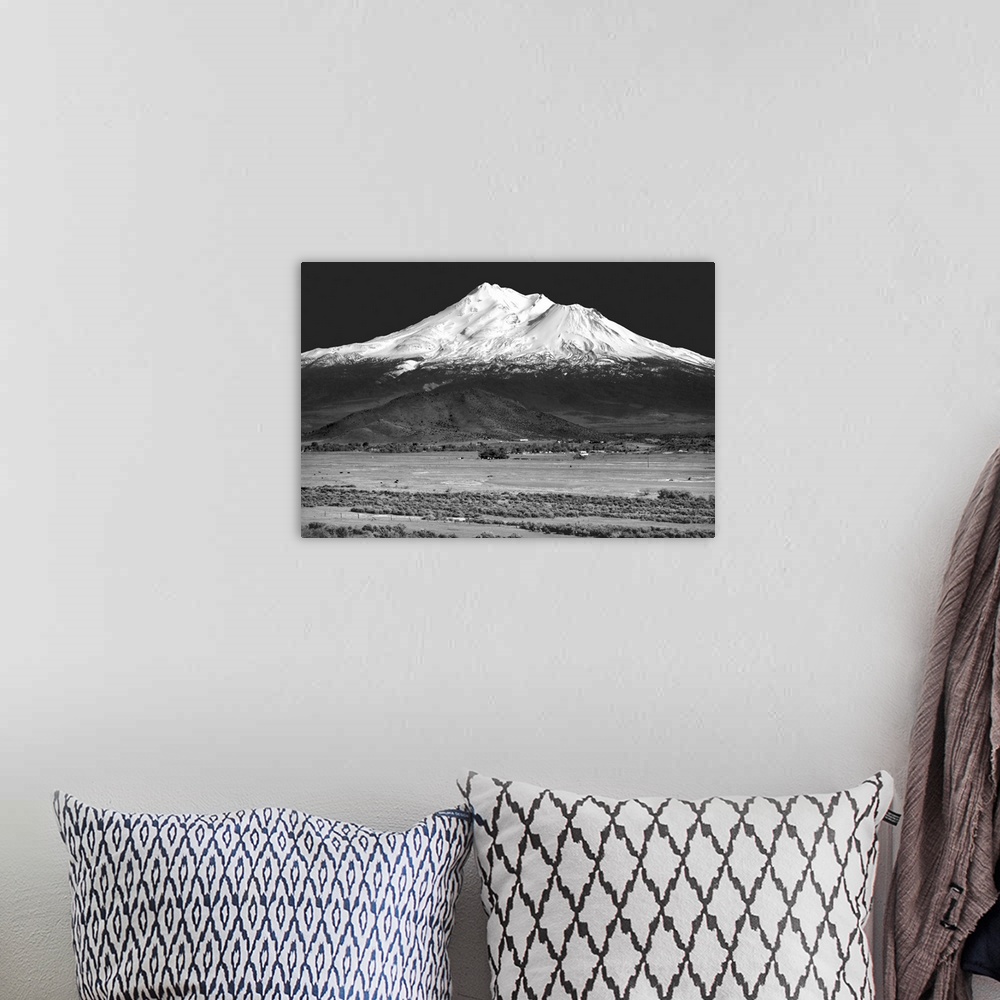 A bohemian room featuring Black and white landscape photograph of Shasta County with a snowy mountain peak in the distance.