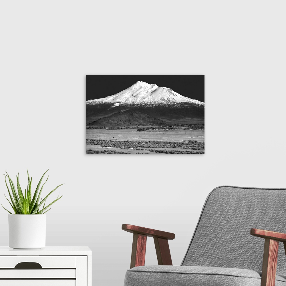 A modern room featuring Black and white landscape photograph of Shasta County with a snowy mountain peak in the distance.
