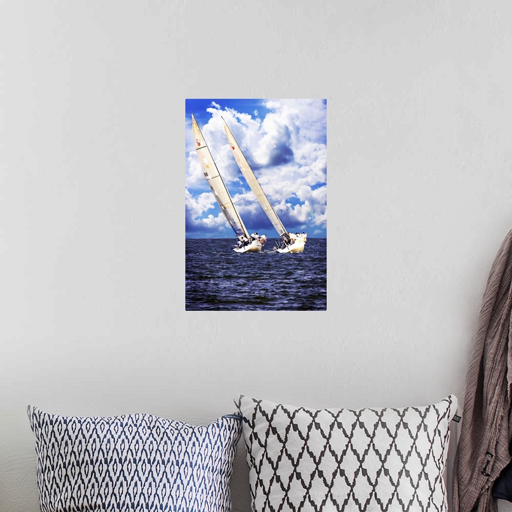A bohemian room featuring Two sailboats on the water leaning against the wind with large clouds in the sky.