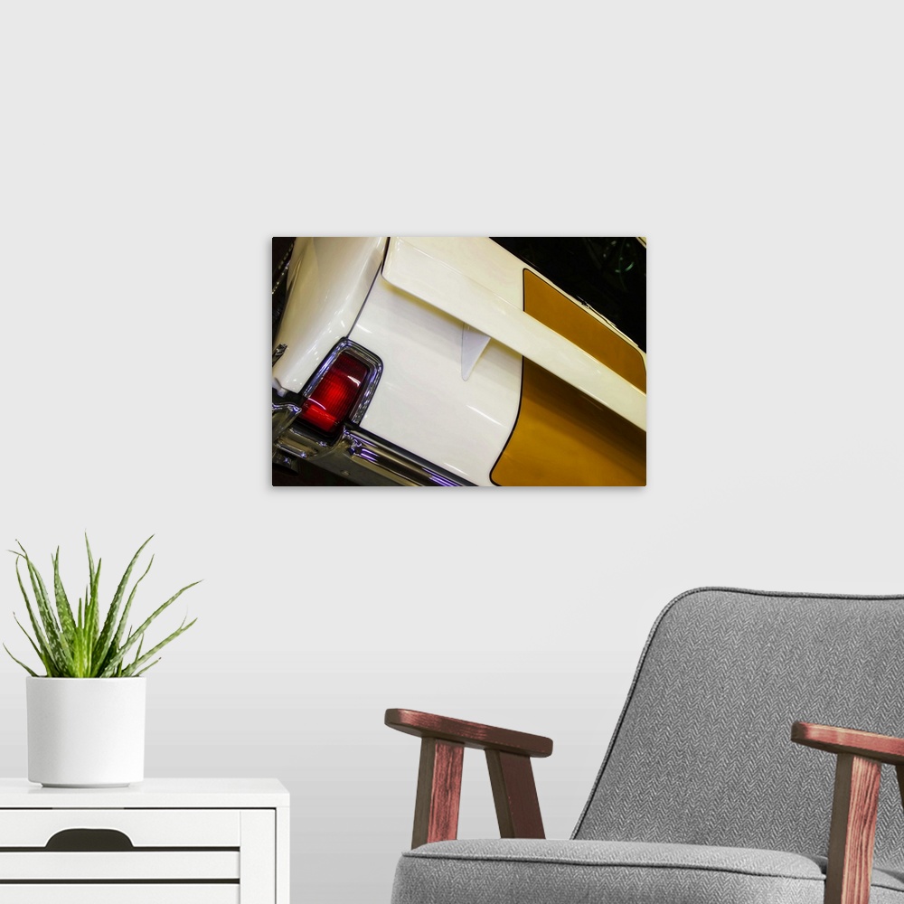 A modern room featuring Fine art photograph of a vintage car. The red taillight of the car stands out.
