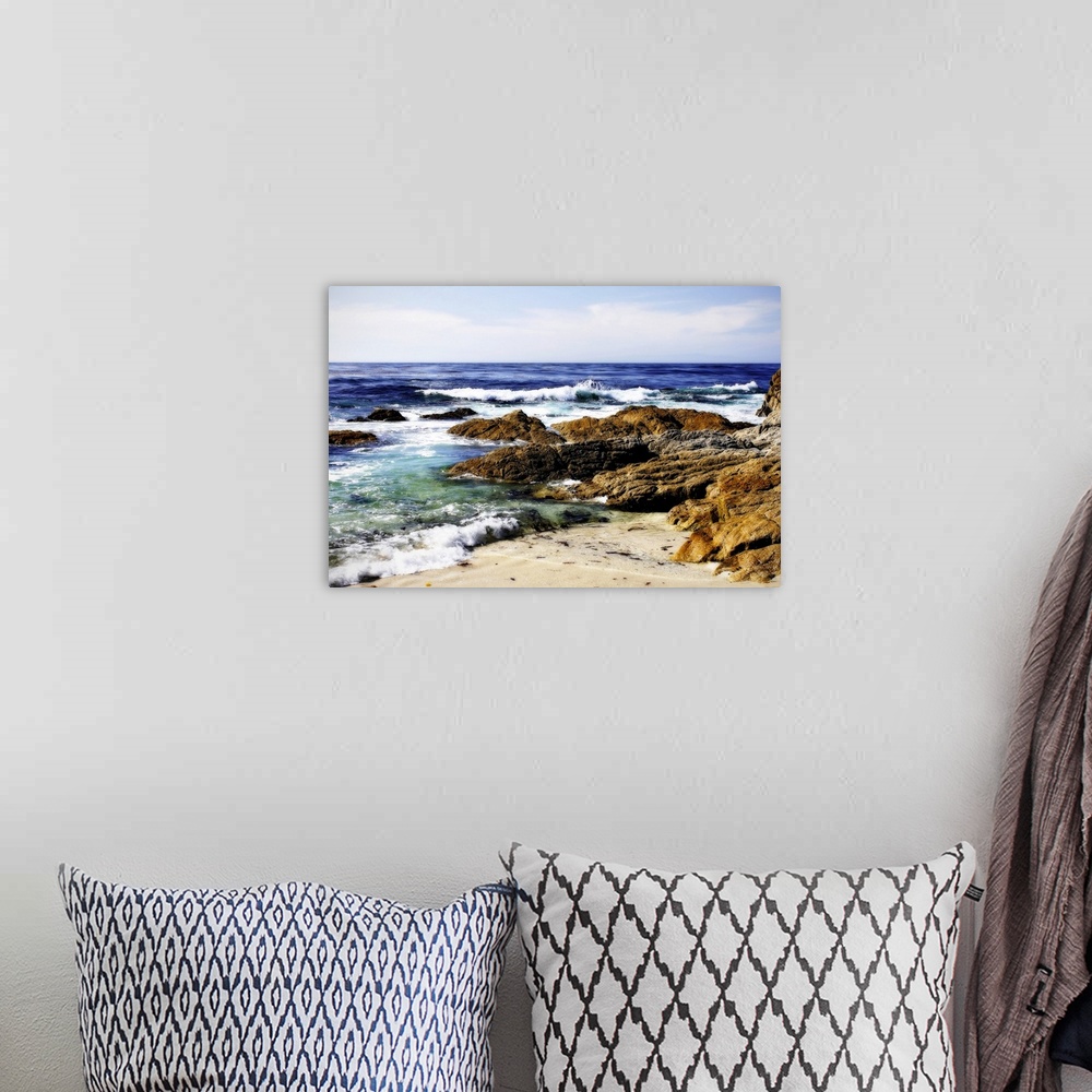 A bohemian room featuring Photograph of rocky shoreline with waves crashing in.