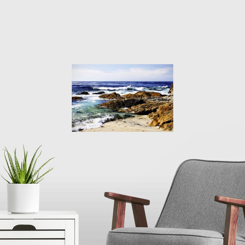 A modern room featuring Photograph of rocky shoreline with waves crashing in.