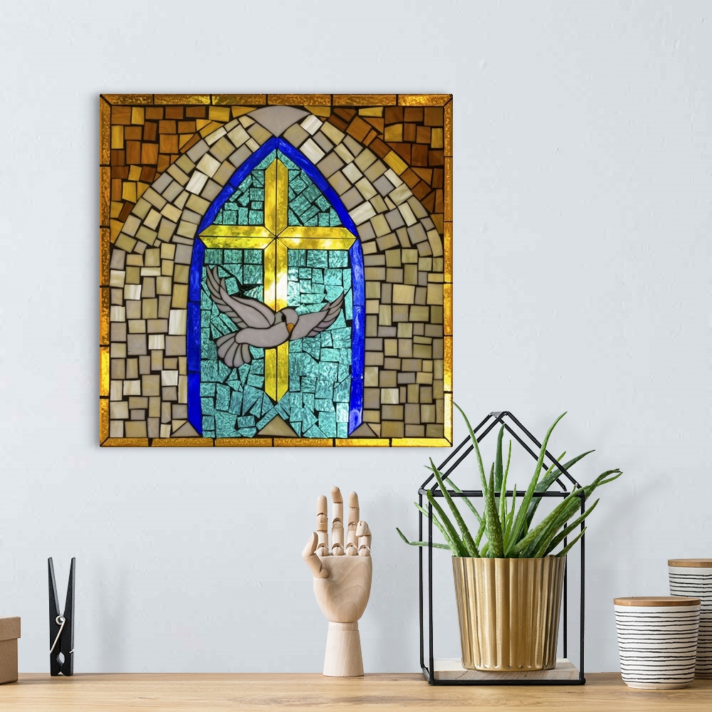 A bohemian room featuring Artwork done in a stained-glass style depicting a cross and dove, symbols of Christianity.