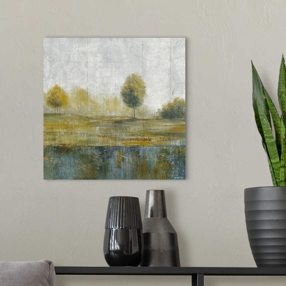 A modern room featuring Contemporary artwork showing a line of trees on land with a body of water just below them. There ...