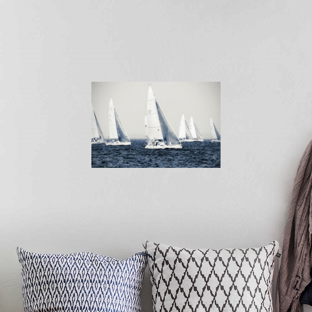A bohemian room featuring Big canvas photo of six sailboats racing on the ocean.