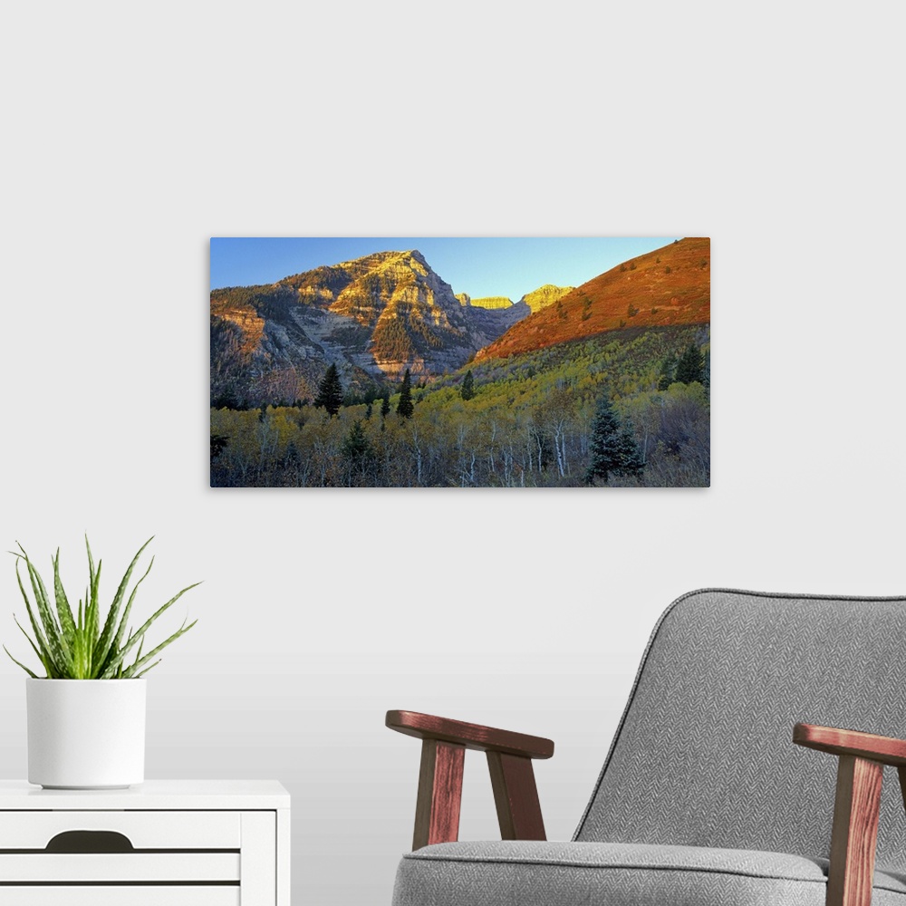 A modern room featuring Light from the setting sun turning the mountains red in Utah.