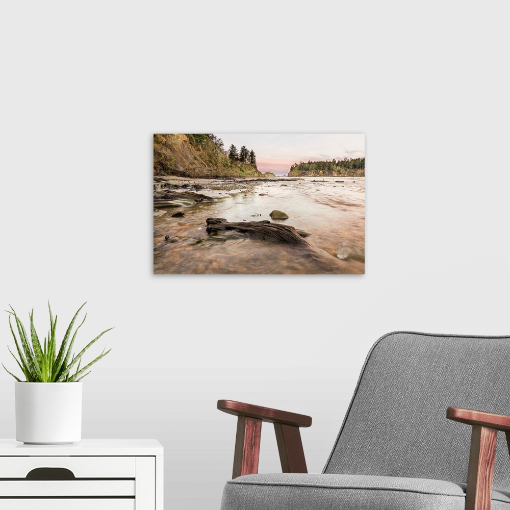 A modern room featuring Landscape photograph of a pink and purple sunrise over the water at Sunset Bay State Park, Oregon.