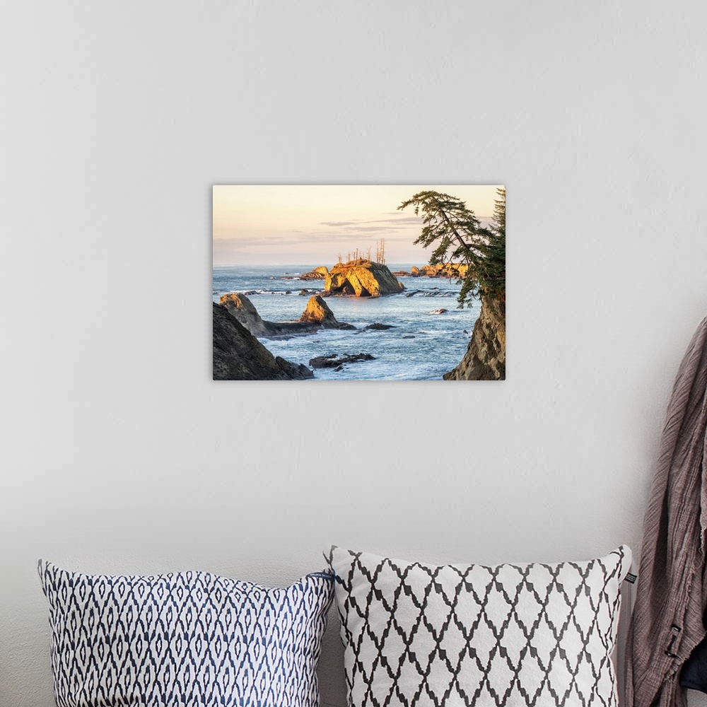 A bohemian room featuring Landscape photograph of the sunset over rock formations in Sunset Bay State Park, Oregon.