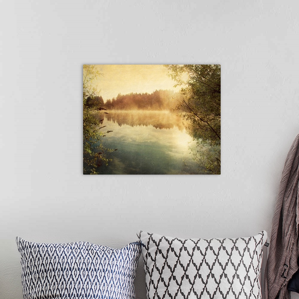 A bohemian room featuring Large photograph taken from between two trees overlooks a calm body of water reflecting the sky a...