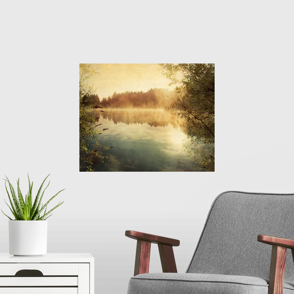 A modern room featuring Large photograph taken from between two trees overlooks a calm body of water reflecting the sky a...