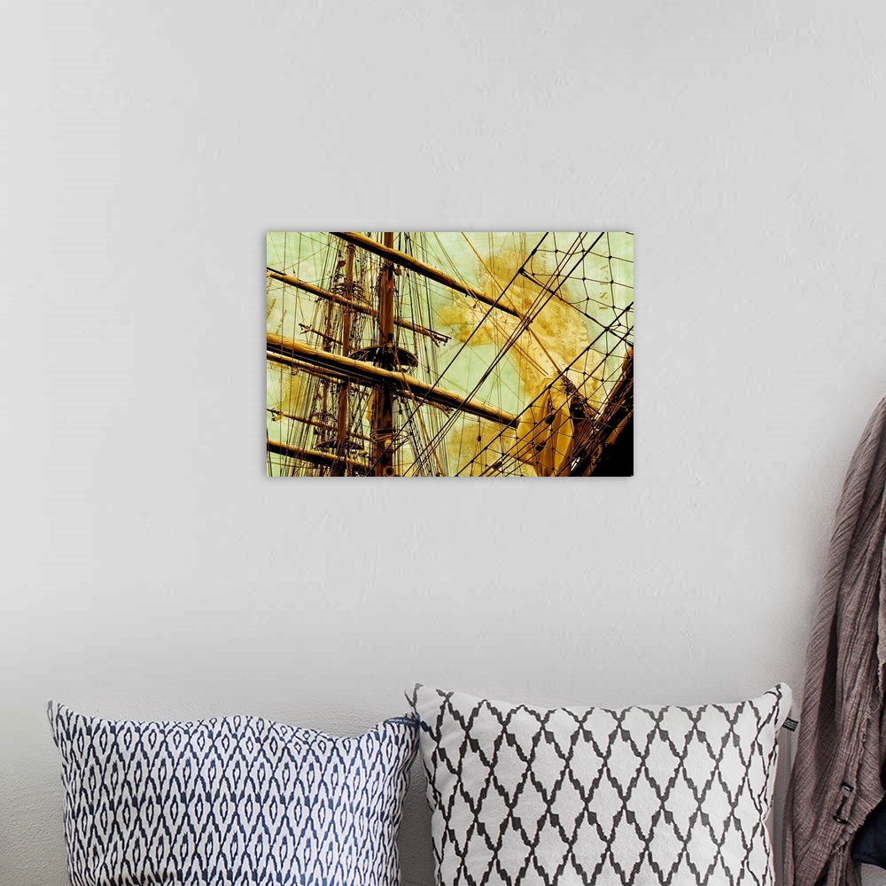 A bohemian room featuring Close-up photograph of a sailboat mast with golden tones and a faded map in the background.