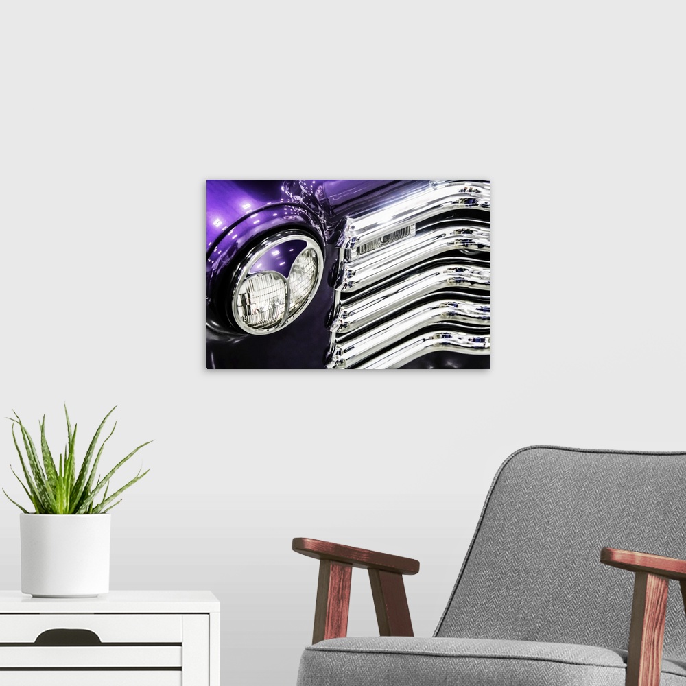 A modern room featuring Headlight and grill detail of a bright purple vintage truck.