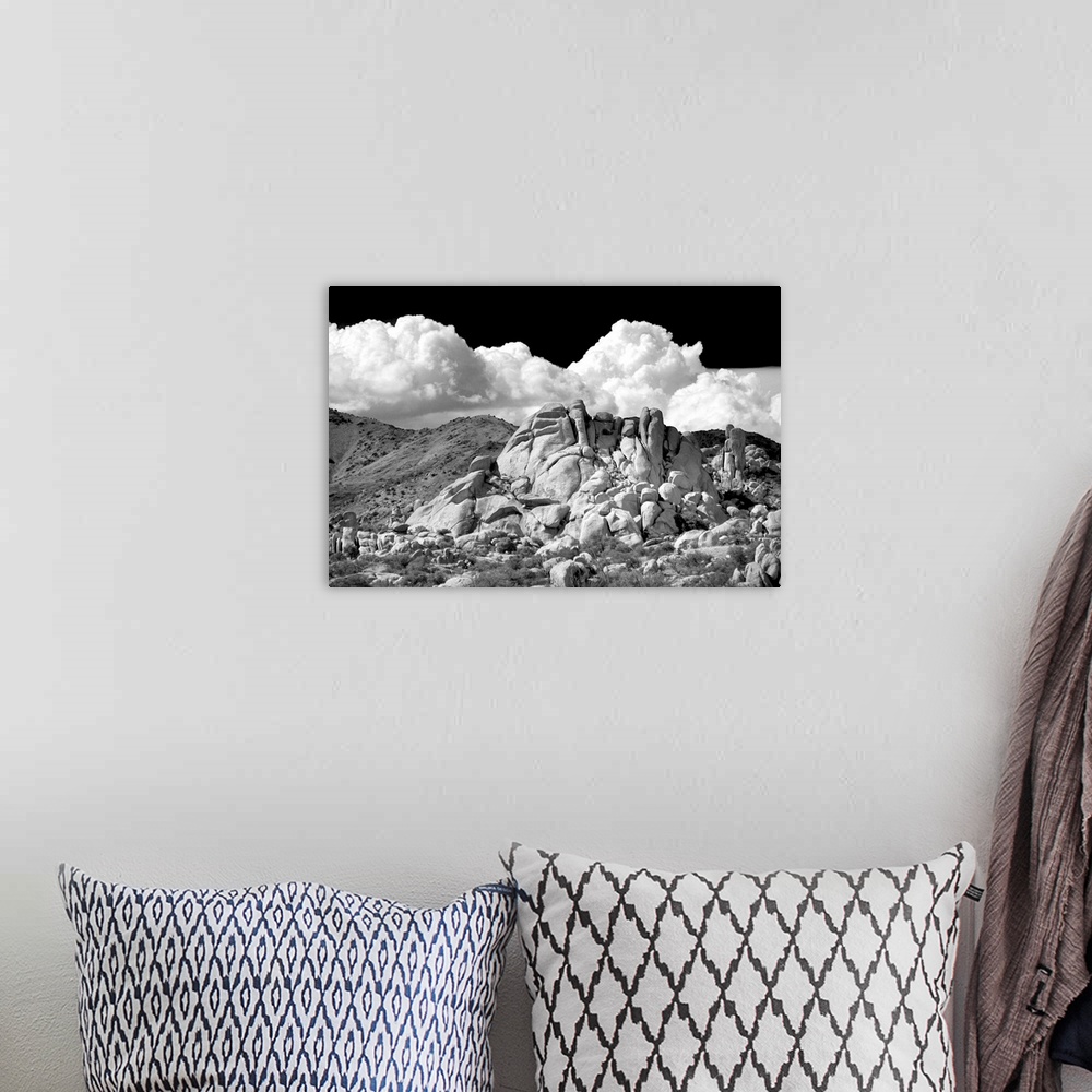 A bohemian room featuring Black and white photograph of canyon rocks with rolling hills in the background and white fluffy ...