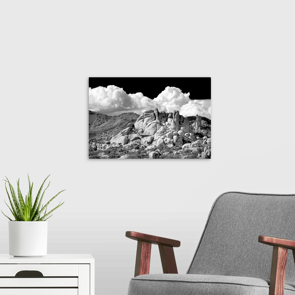 A modern room featuring Black and white photograph of canyon rocks with rolling hills in the background and white fluffy ...