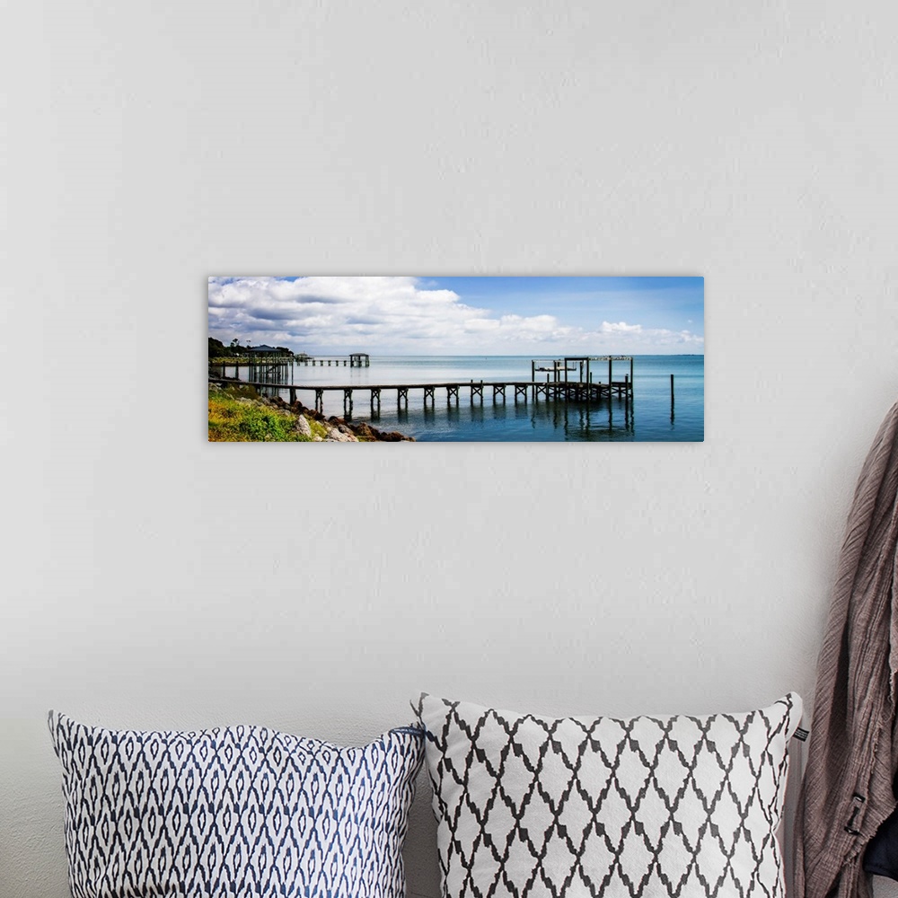A bohemian room featuring Panoramic photograph of a dock stretched out over the Thorofare Bay in North Carolina.