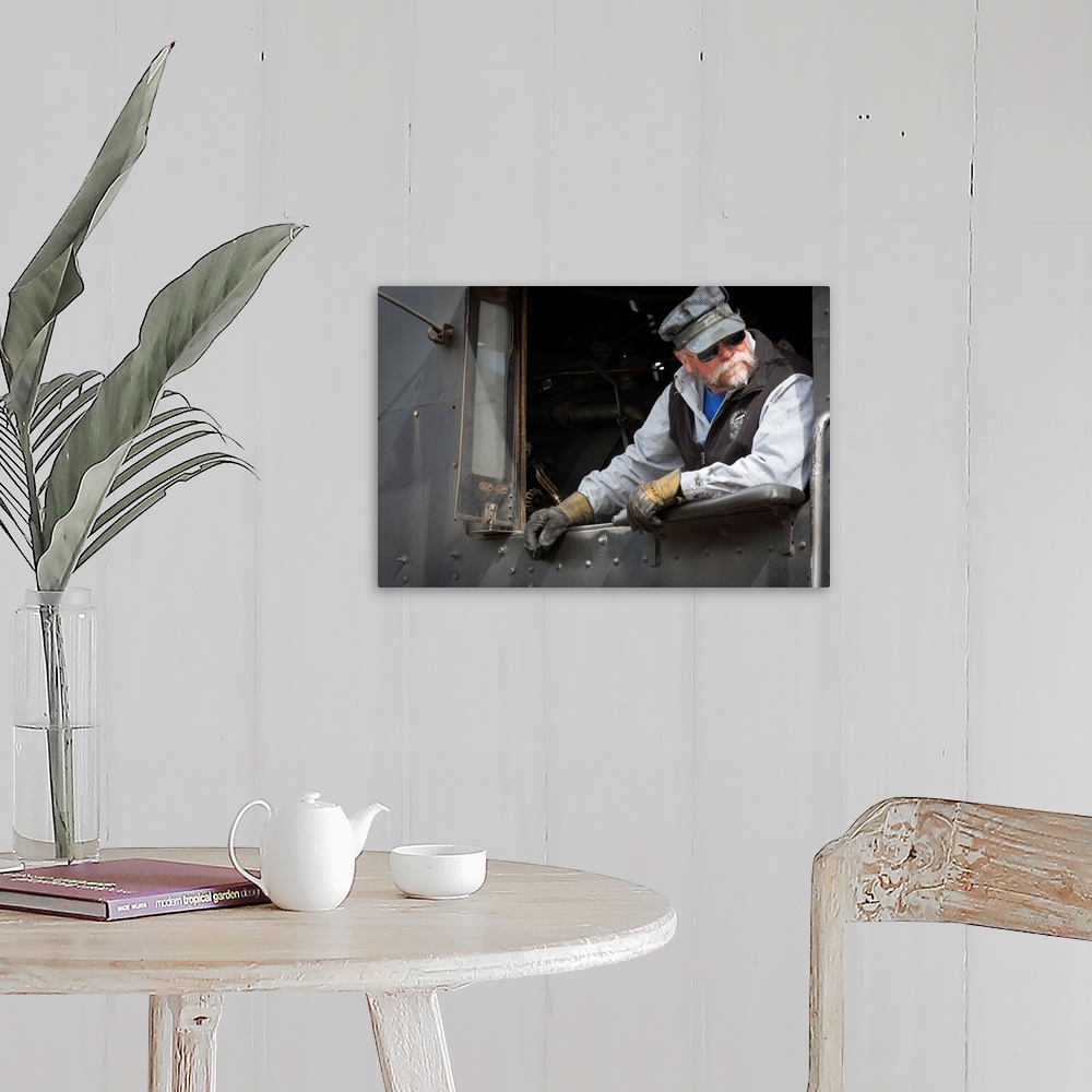 A farmhouse room featuring Photograph of a train engineer in vintage clothes.