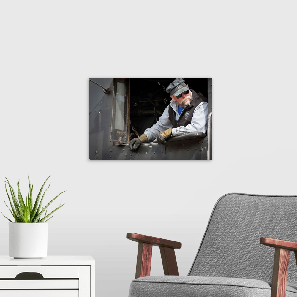 A modern room featuring Photograph of a train engineer in vintage clothes.