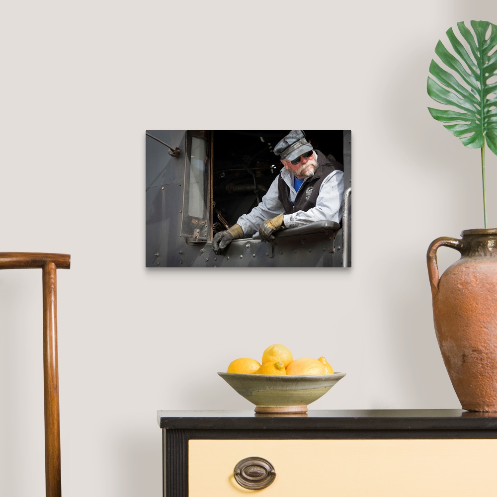 A traditional room featuring Photograph of a train engineer in vintage clothes.