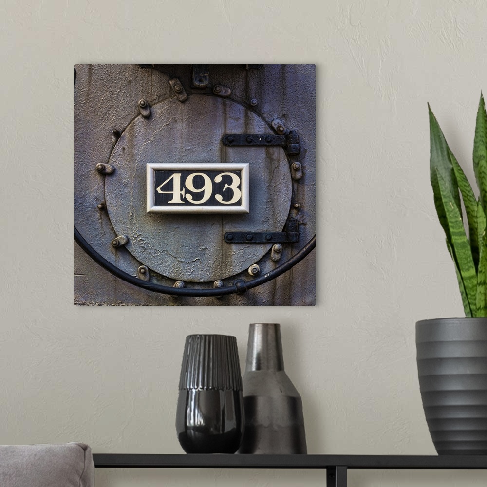 A modern room featuring Photograph of weathered detail from a vintage train locomotive.