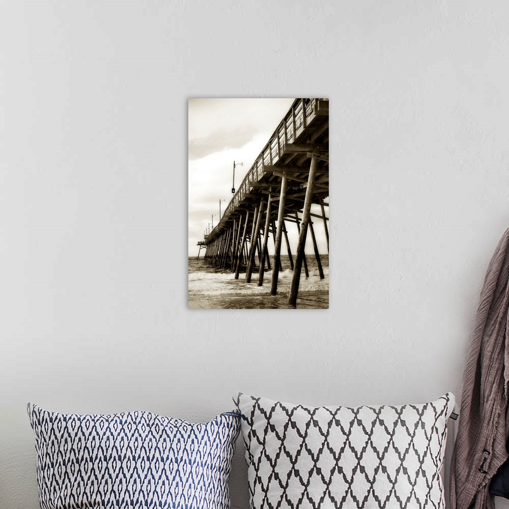 A bohemian room featuring Photograph of dock stretching into ocean under cloudy sky.