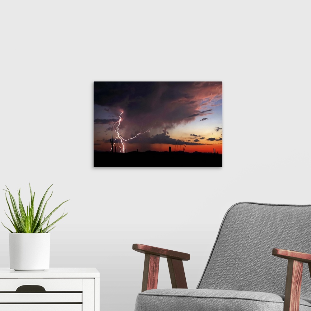 A modern room featuring Silhouetted landscape photograph of a desert sunset with dramatic clouds and lightning bolts.