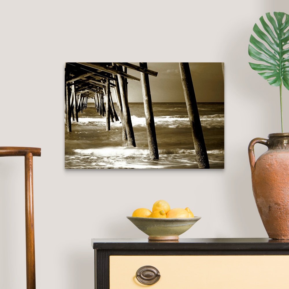 A traditional room featuring Photograph underneath a wooden pier with waves rolling in.