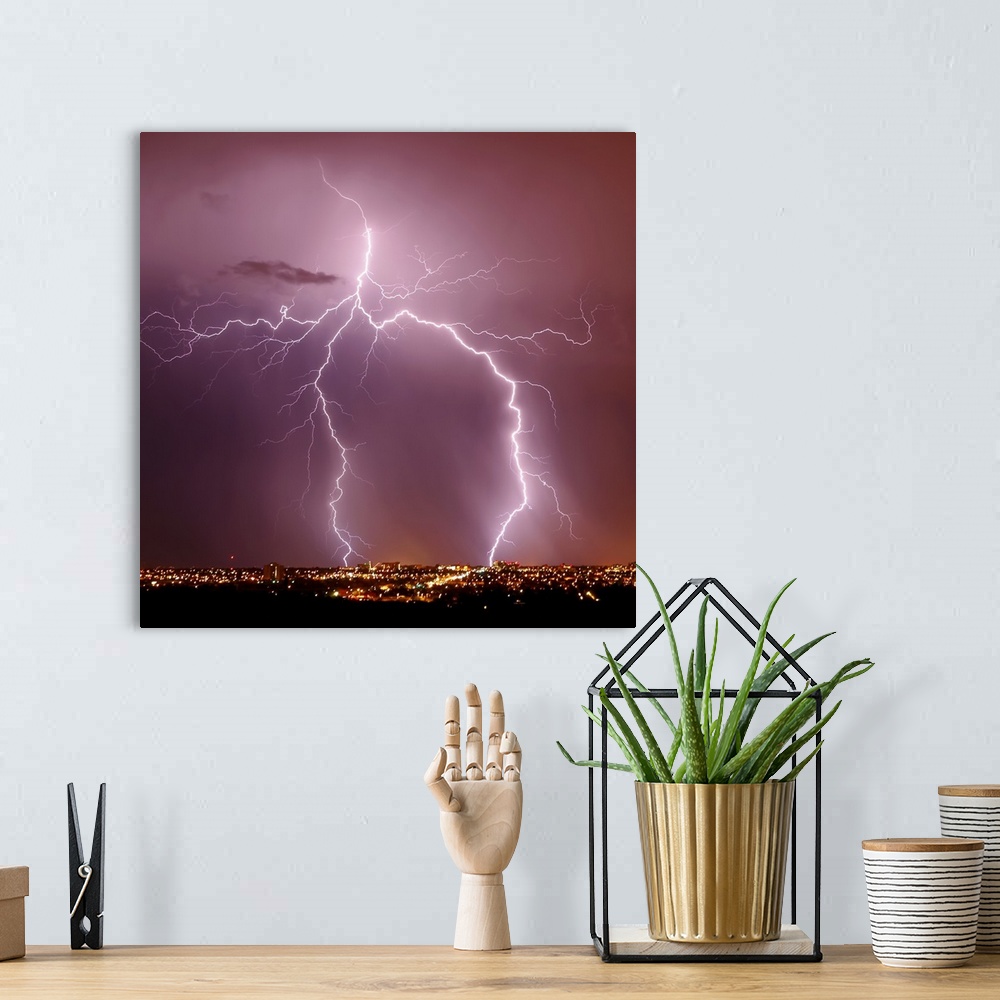 A bohemian room featuring Square photograph of lightning striking above a city in Arizona.