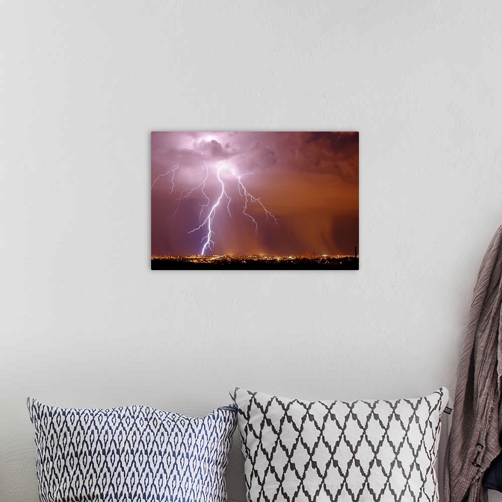 A bohemian room featuring Photograph of lightning striking in an orange, pink, and purple sky above a city in Arizona.
