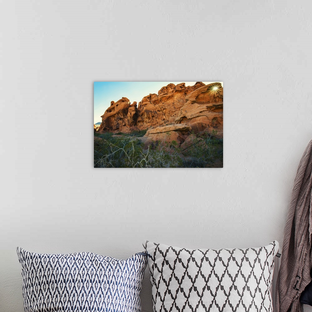 A bohemian room featuring Landscape photograph of sandstone rock formations with the sun shining through an arch at Valley ...