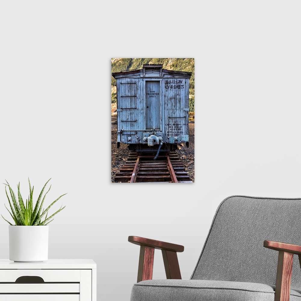 A modern room featuring Photograph of a vintage train car on the railroad tracks.