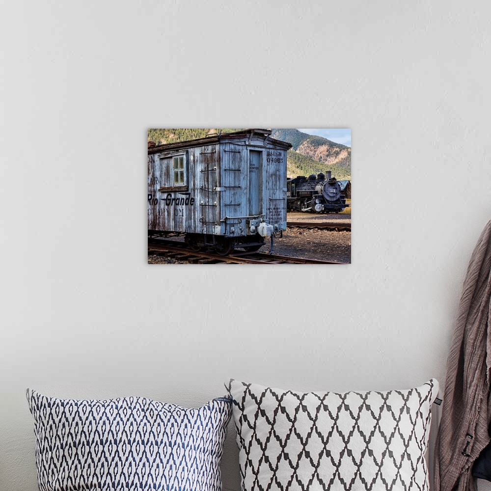 A bohemian room featuring Photograph of a vintage train car on the railroad tracks.