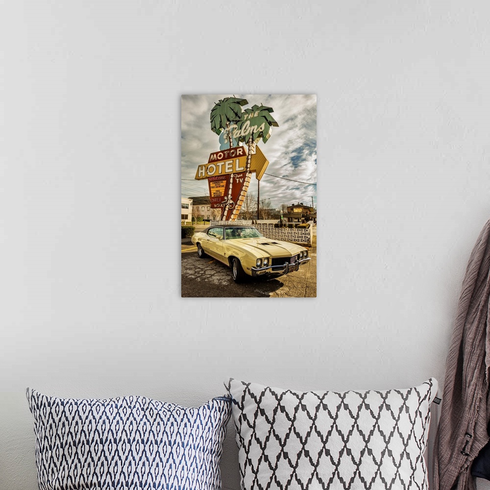 A bohemian room featuring HDR photo of a vintage car parked in front of a motel with a retro neon sign.