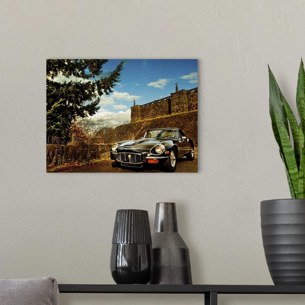 A modern room featuring HDR photo of a vintage car parked near a fortress in a desert.