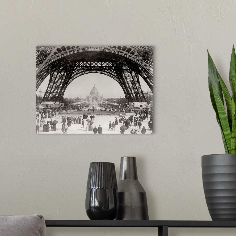 A modern room featuring Vintage photograph of people standing under the base of the Eiffel Tower in Paris.