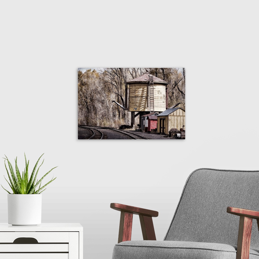 A modern room featuring Photograph of old railroad tracks.