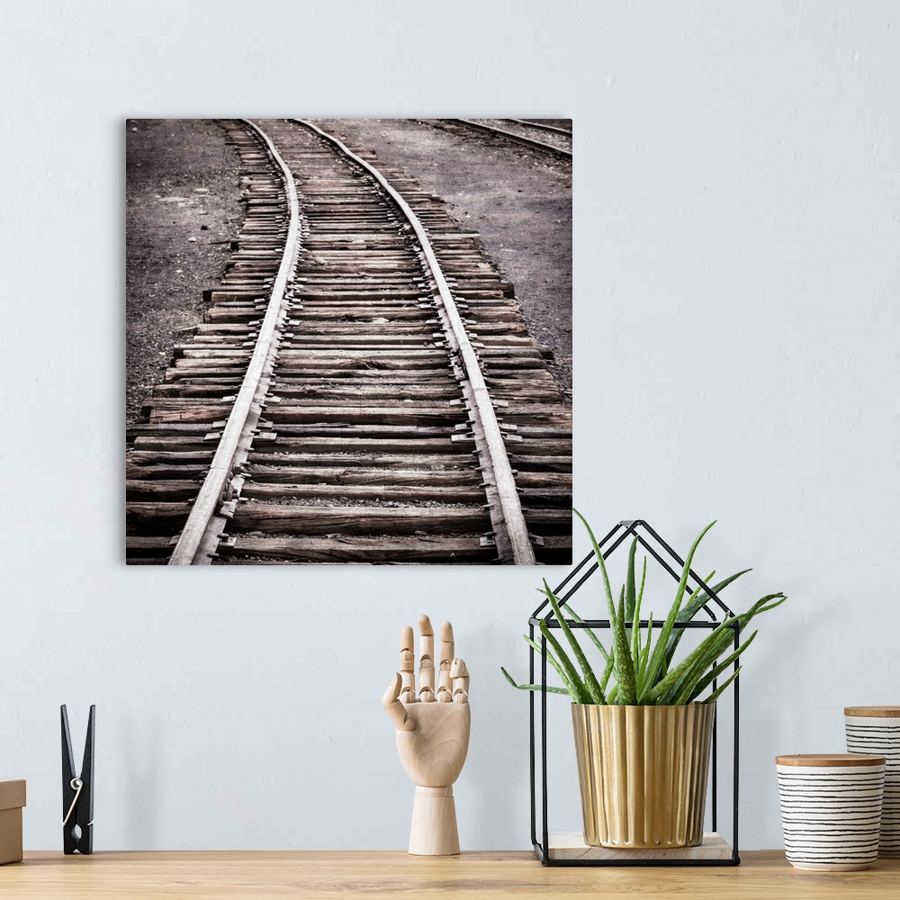 A bohemian room featuring Photograph of a railroad passing through an old train yard.