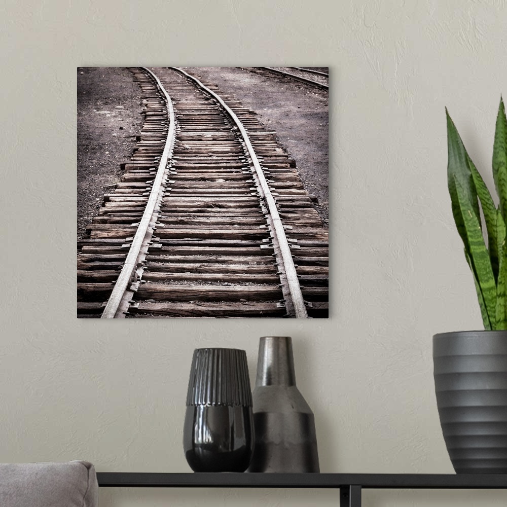 A modern room featuring Photograph of a railroad passing through an old train yard.